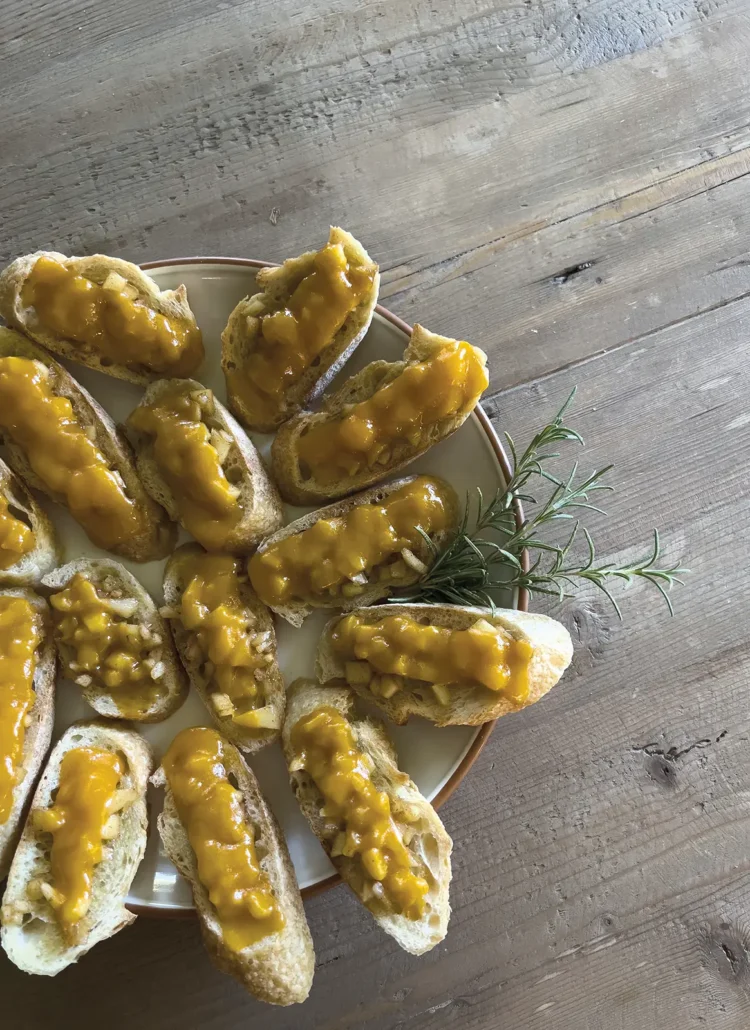 Apple crostini artfully arranged on a plate.