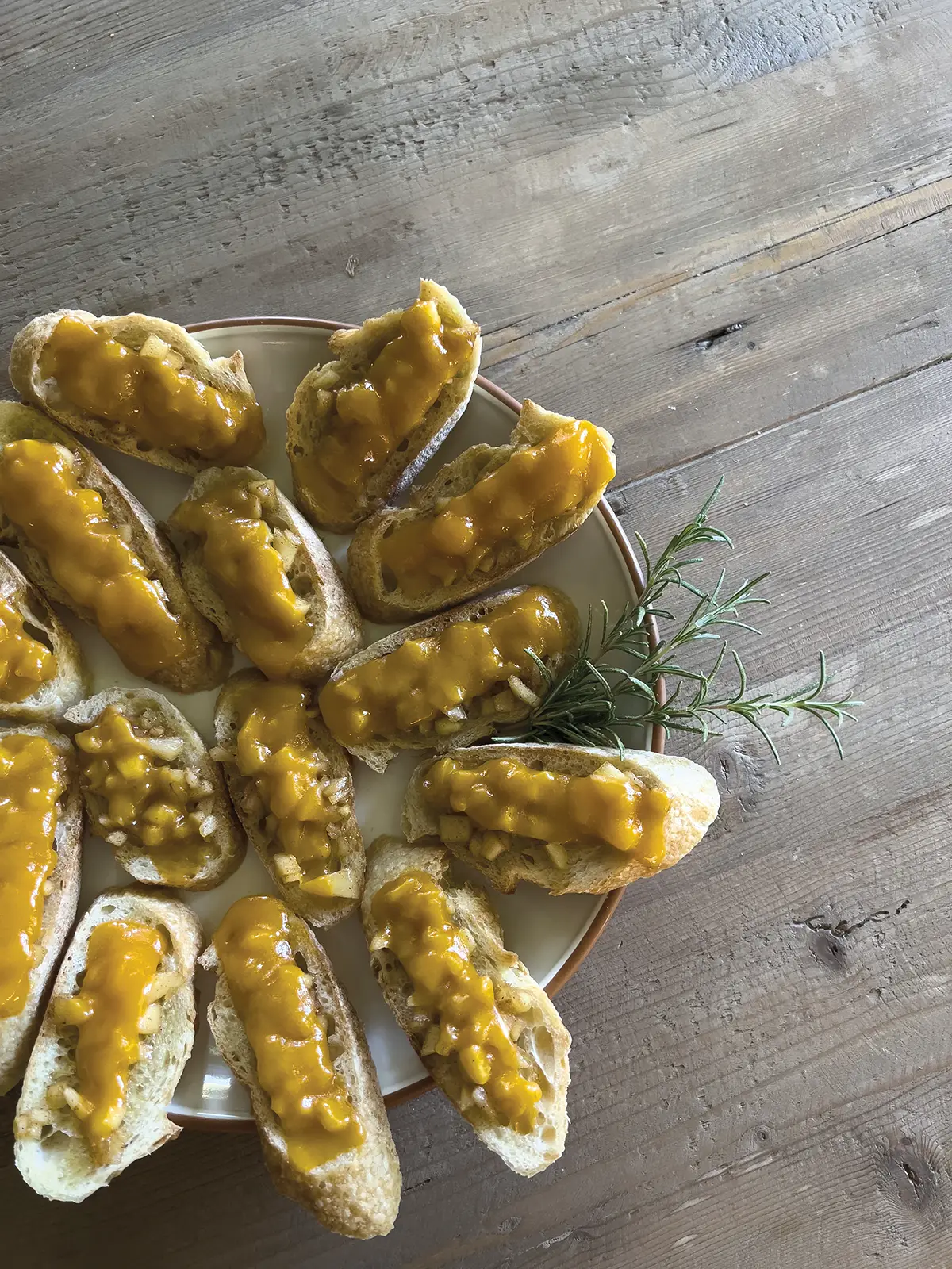 Apple crostini artfully arranged on a plate.