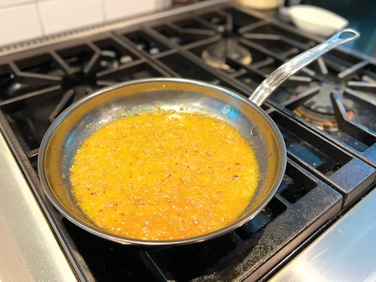 Chardonnay shallot sauce simmering in a sauté pan.