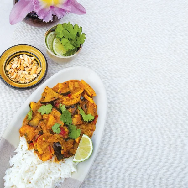 A bowl of eggplant curry over jasmine rice.