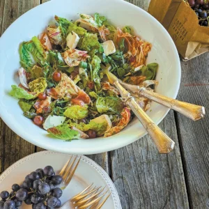 A bowl of Grape Harvesters Salad with Pesto Vinaigrette.