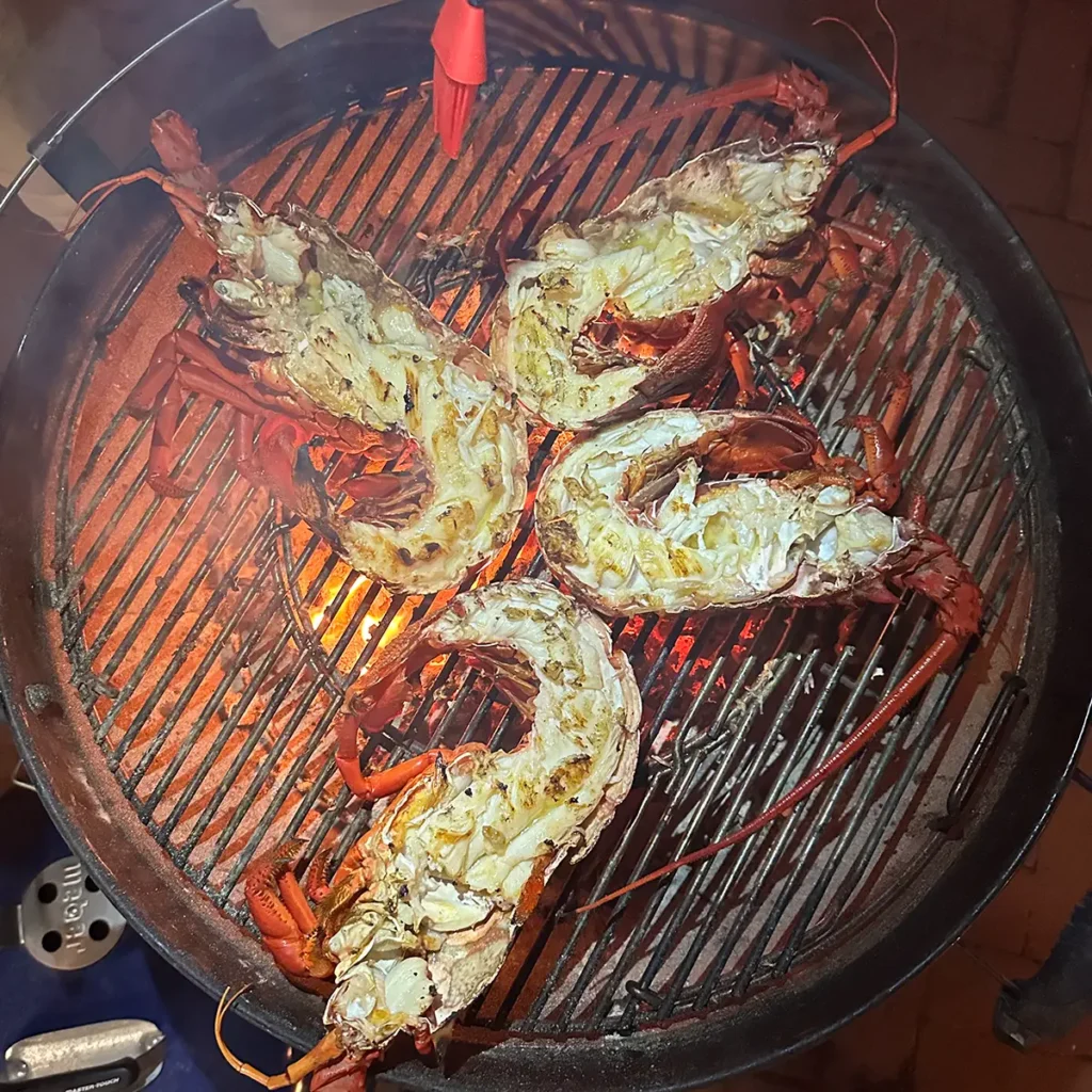 Spiny lobsters cooking on the grill.