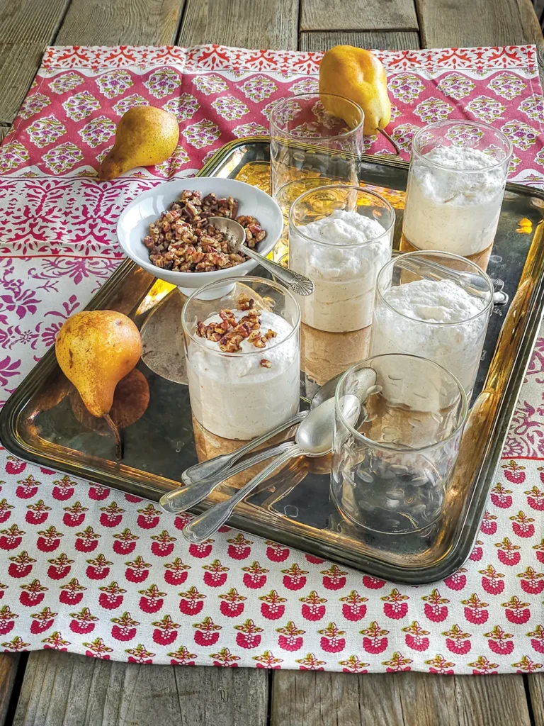 A tray holding pears and glasses of pear mousse.