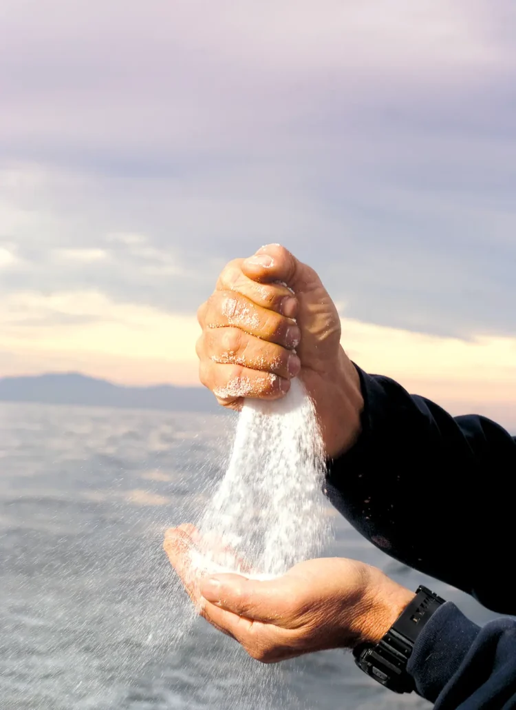 Crabby Steve Escobar pours salt from hand to hand while at sea in the Santa Barbara channel.