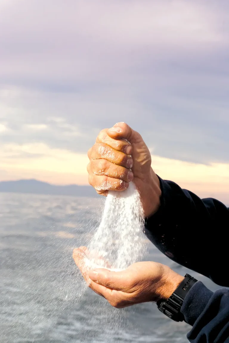 Crabby Steve Escobar pours salt from hand to hand while at sea in the Santa Barbara channel.