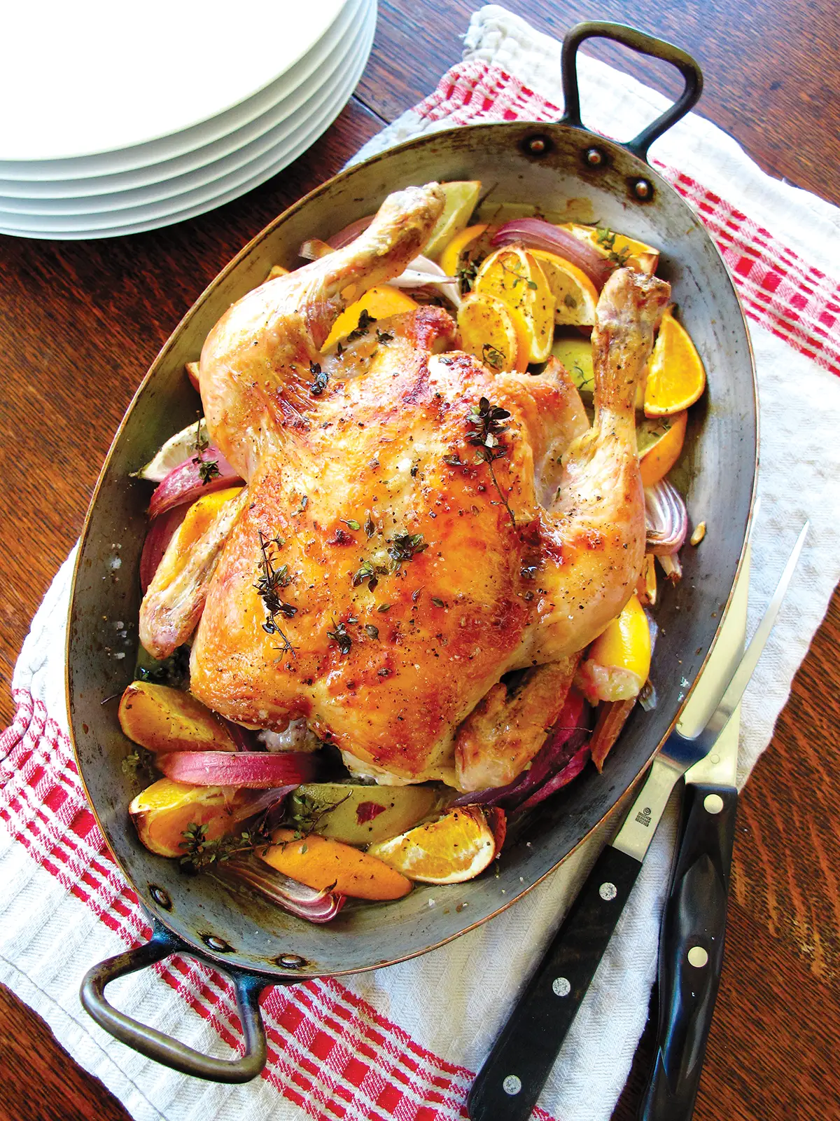 French roasting pan containing a Roast Chicken with Tarragon, Vegetables and Little Potatoes.