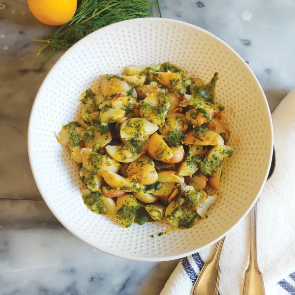 A bowl of Steamed Spring Potatoes with Dill-Chive Vinaigrette.