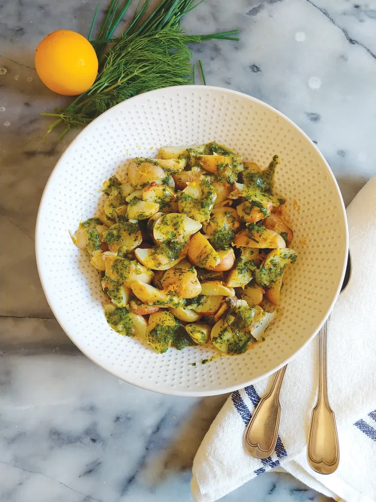 A bowl of Steamed Spring Potatoes with Dill-Chive Vinaigrette.