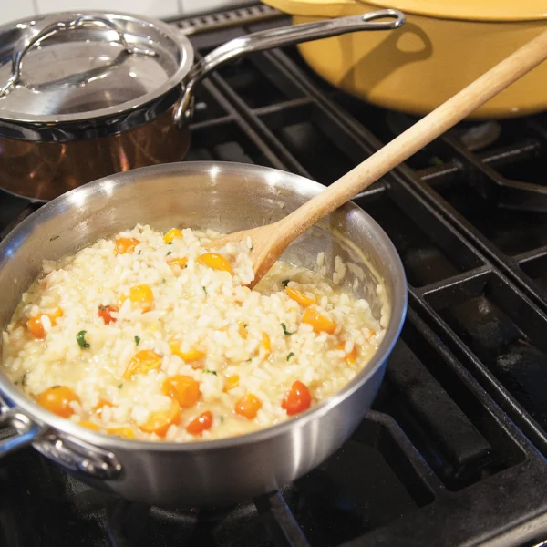 White Wine Risotto with Cherry Tomatoes in a pot cooking on the stove.