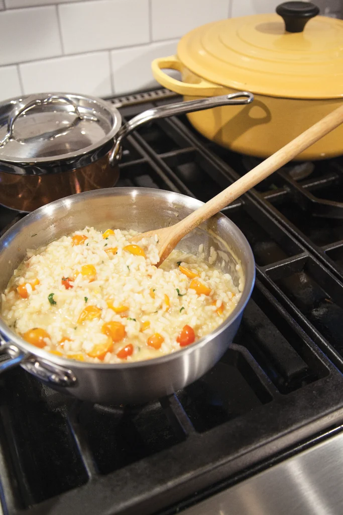 White Wine Risotto with Cherry Tomatoes in a pot cooking on the stove.