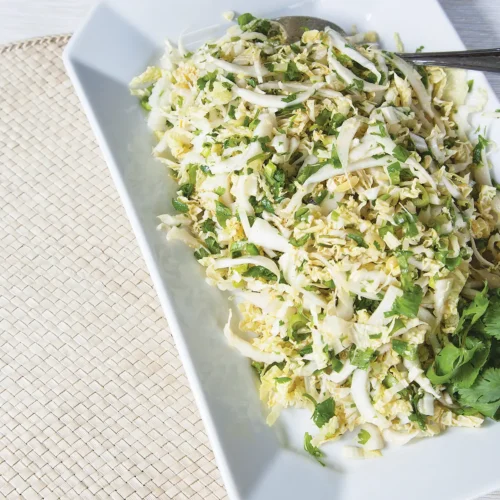 White serving platter containing spicy cabbage slaw.