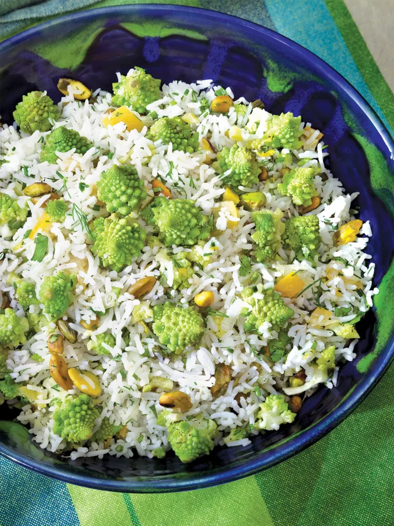 A blue and green bowl containing herbed lemon rice with romanesco.