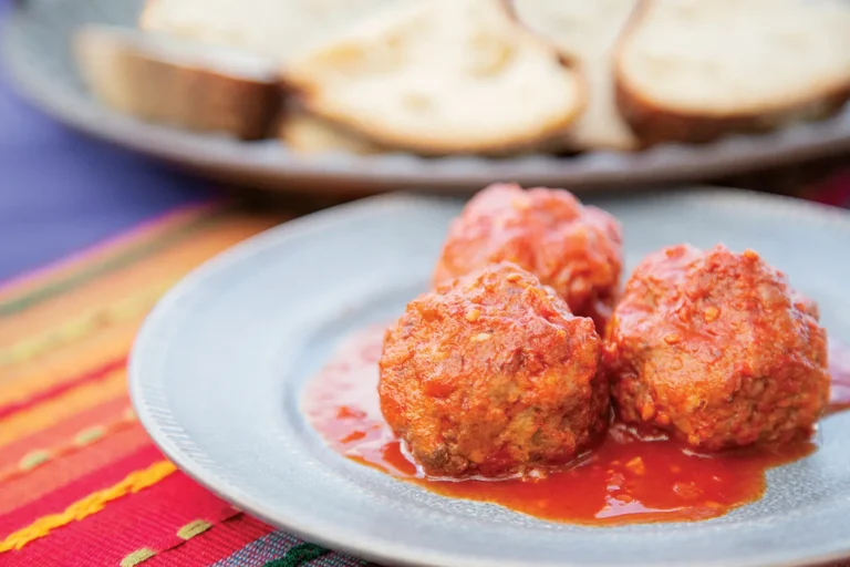 Rabbit Albondigas in Tomato Sauce on a pastel plate.