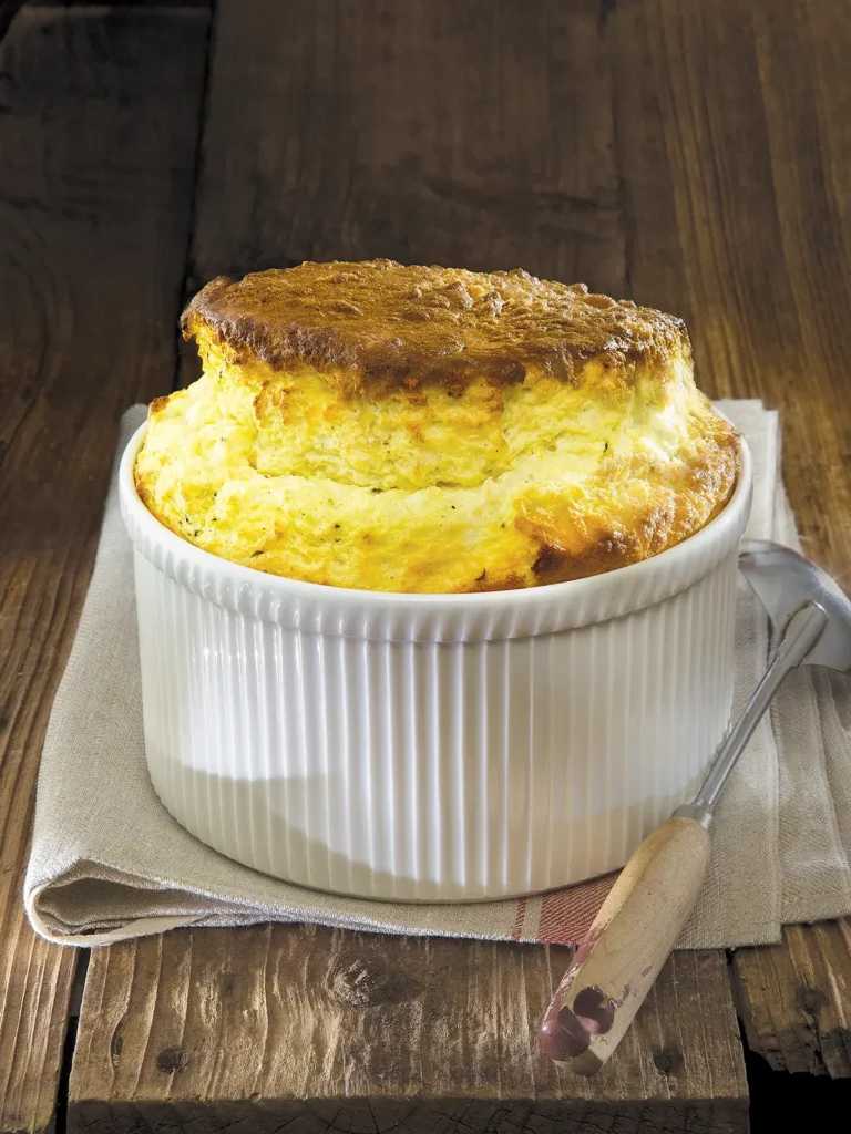 Cheese souffle on a wooden table.