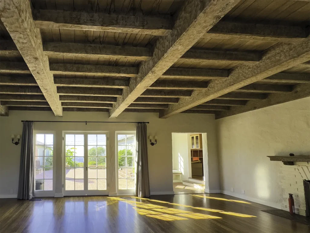 Room with large wooden beam ceiling.