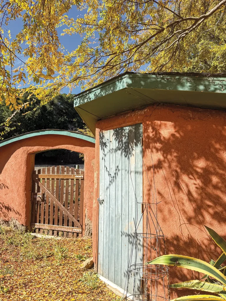 Orange stucco building and gate at Sunburst Sanctuary.