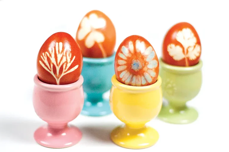 Naturally died eggs in colorful egg cups.