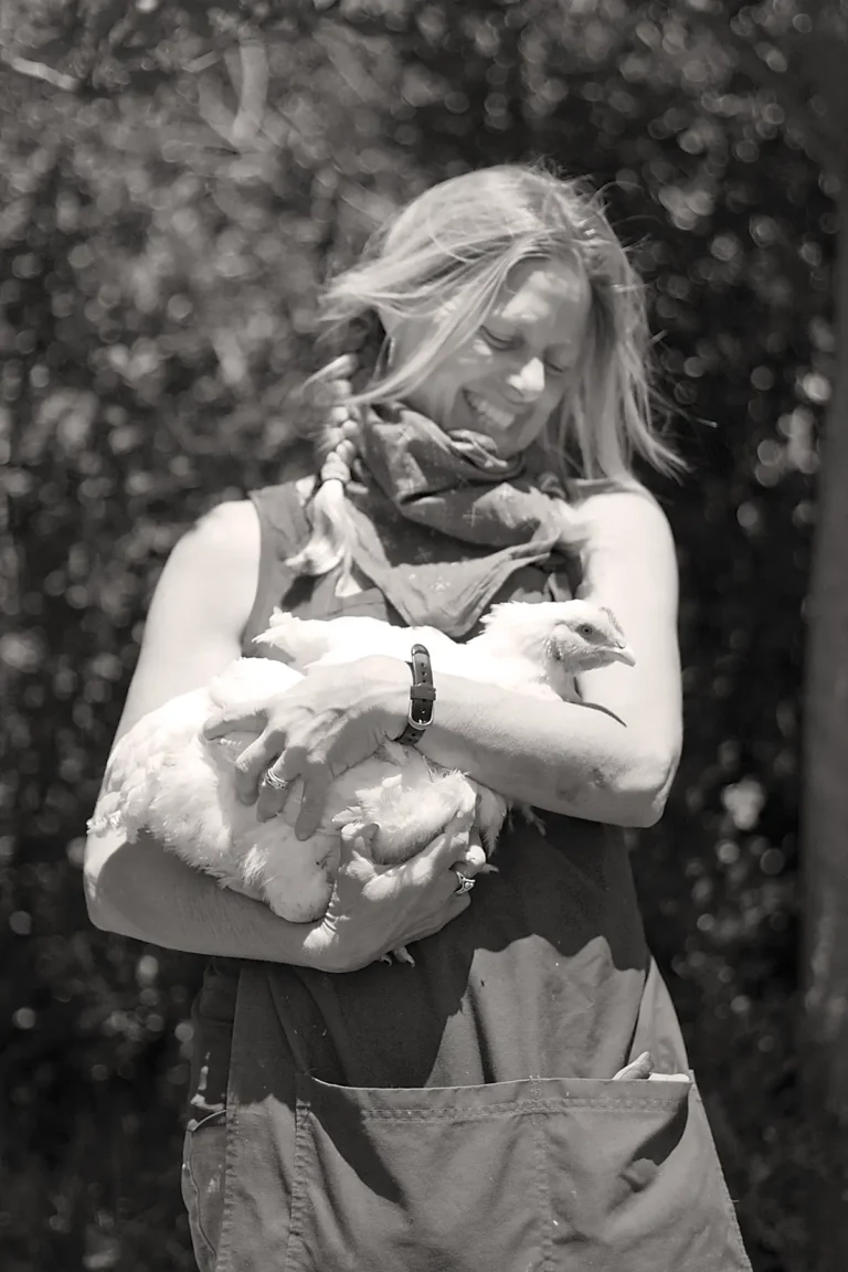 Heidi Tautrim holds a chicken at Orella Ranch.