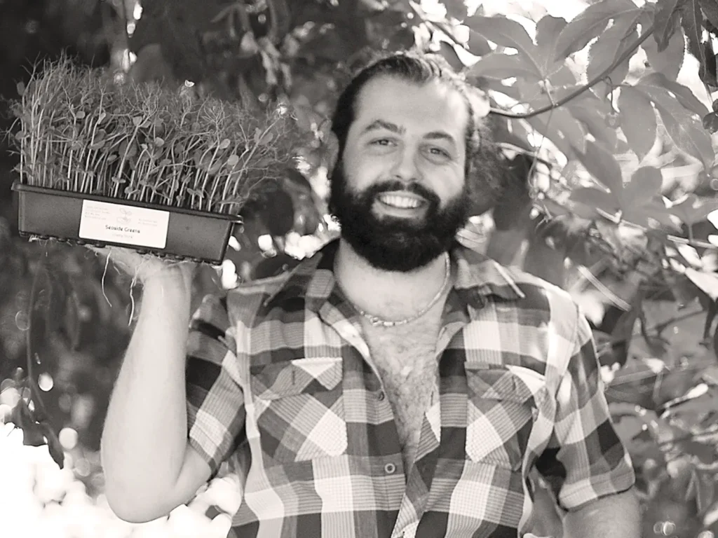 Julian Cantando holding a flat of greens.