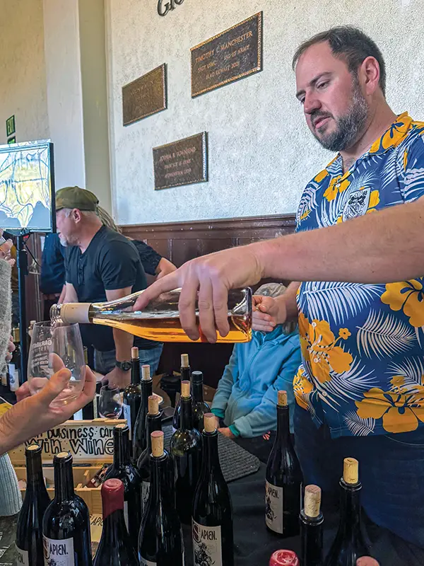 Trevor Bethke from Sapien Wines pouring for a guest.