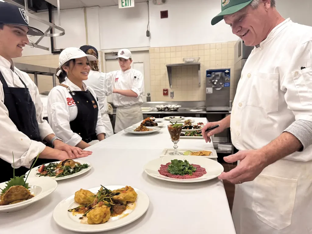 Chef Charlie examines the plating before service.
