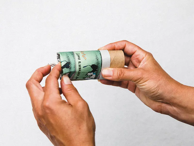 Step 2: Tucking the newspaper into the toilet paper roll.