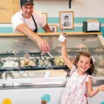 Alessio Carnevale and his youngest daughter Guilia in front of his gelato case.