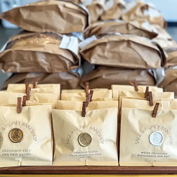 Bags of baked goods from local artisans arranged neatly on a display table.