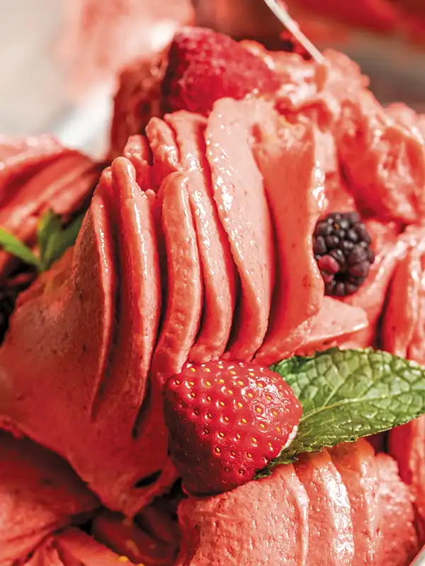 A swirl of mixed berry gelato in the gelato case.
