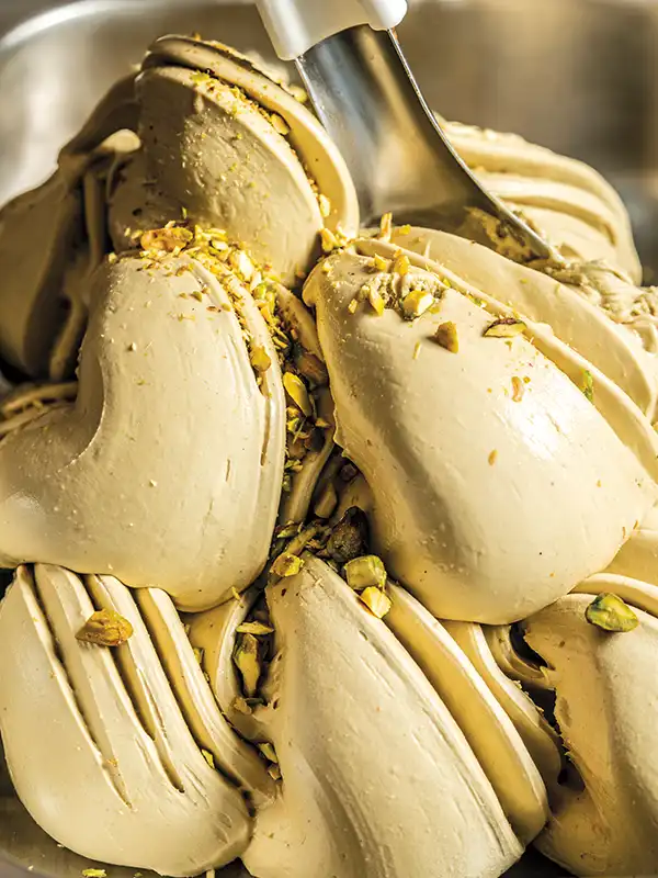 A swirl of pistachio gelato in the gelato case.