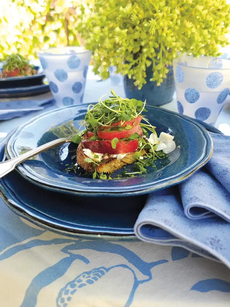 White Peach, Goat Cheese and Herb Crostini in a blue bowl.