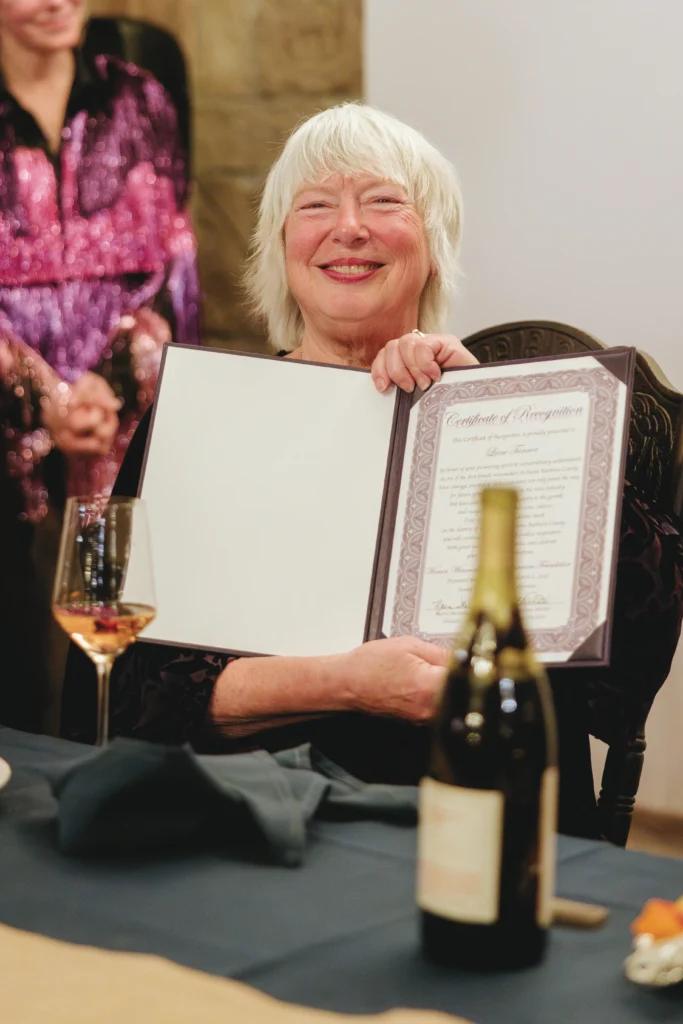 Lane Tanner holding an award.