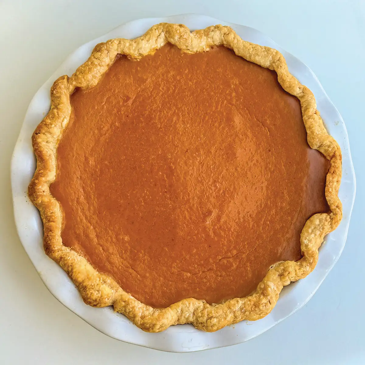 Metro's Pumpkin Pie in a scalloped white pie dish.