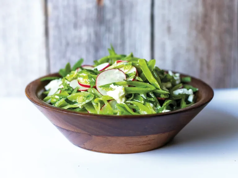 Walnut salad bowl containing Lágrimas Salad with Snap Peas, Radishes and Mint