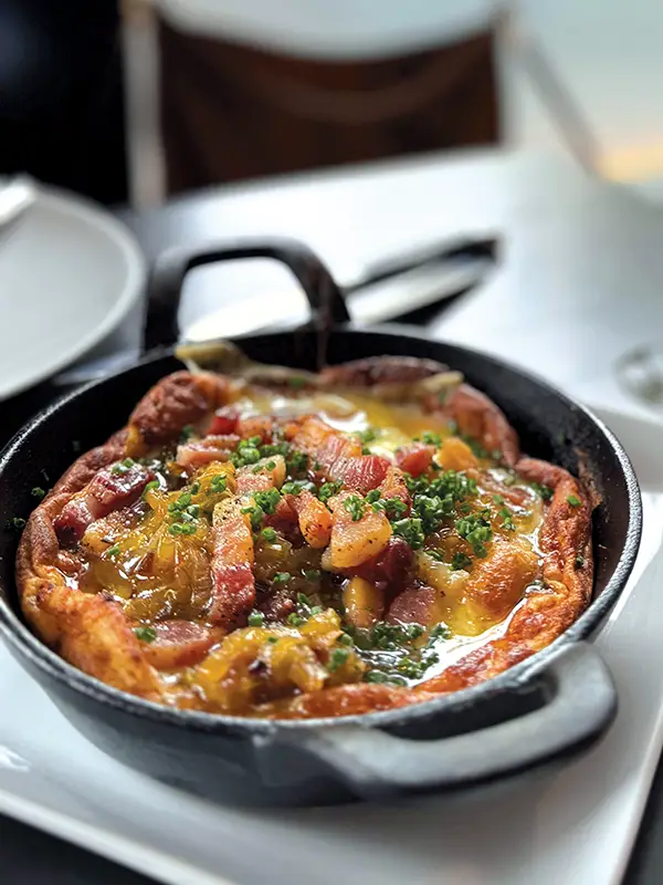 Savory Dutch Baby in a single-serving cast iron skillet.