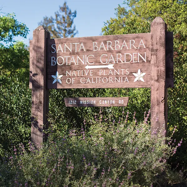 A rustic wooden sign welcomes visitors to the Santa Barbara Botanic Garden, celebrating California's native plants at the entrance on Mission Canyon Road.
