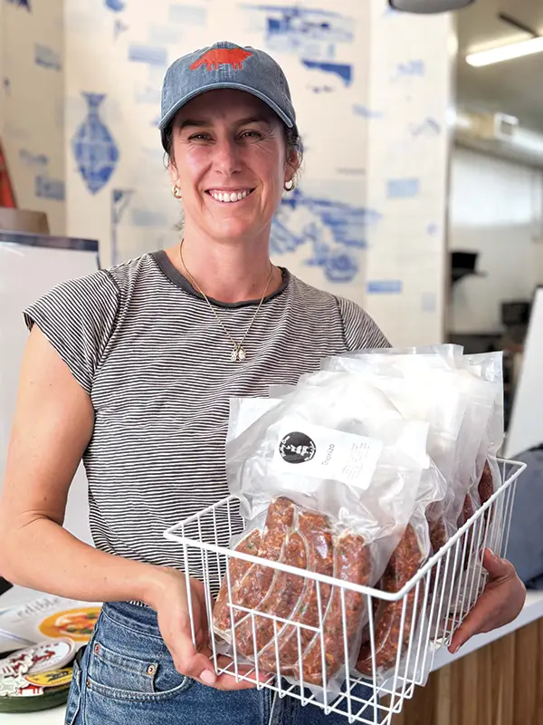 Caroline Hernandez with Motley Crew sausages at Coyote's Market.