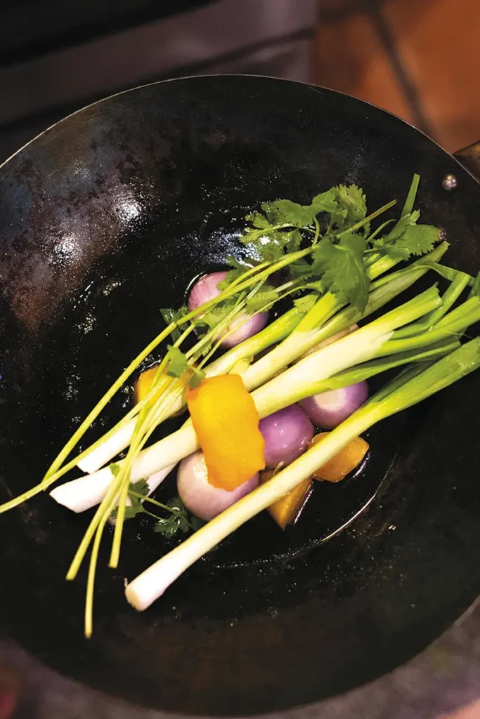 A bed of aromatics in a wok.