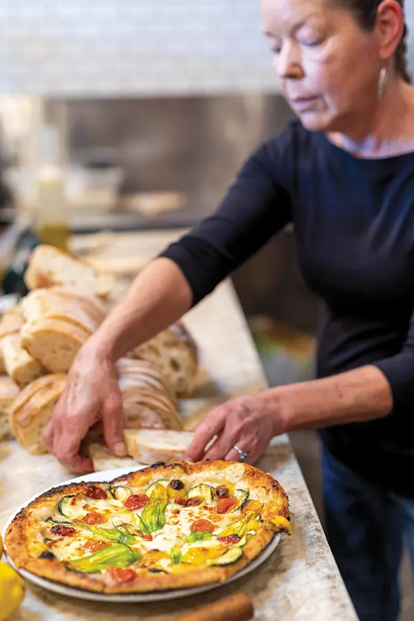Janet Olsson prepares bread and pizza.