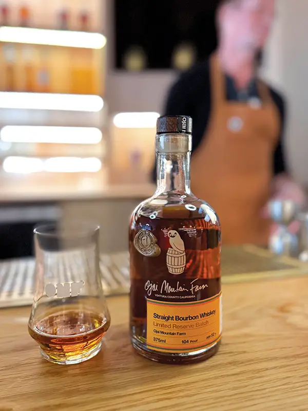 A bottle of Ojai Mountain Farm Limited Reserve Batch Straight Bourbon Whiskey sitting on the bar.