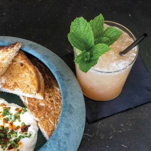 Whipped ricotta with chili crisp and sourdough, and the peach habanero shrub.