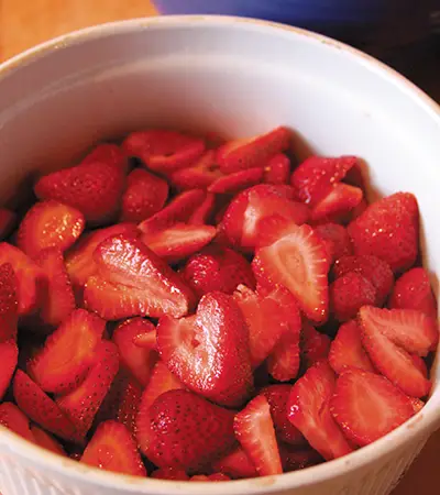 Cut strawberries in a baking dish.