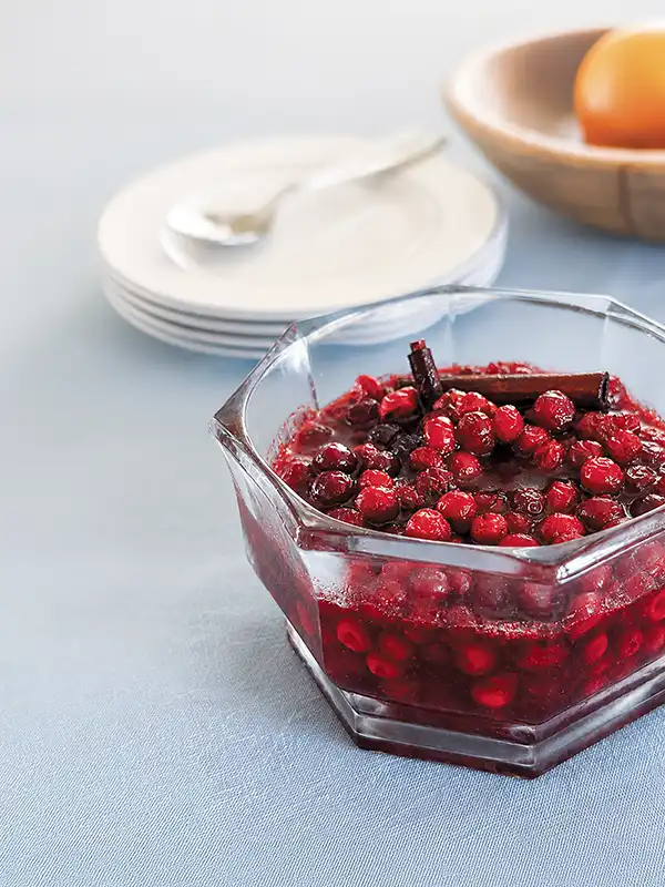 Glass bowl containing cranberry sauce.